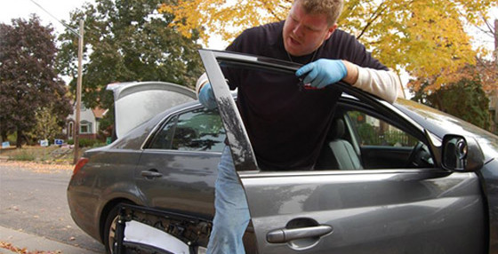 Man working on auto glass repair providing highest quality